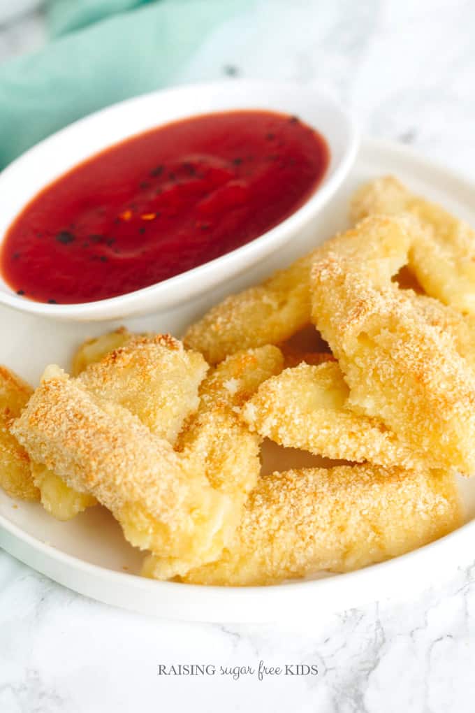 Baked Mozzarella Sticks | Raising Sugar Free Kids - these cheesy snacks are tasty, healthier mozzarella sticks. Alongside a sugar free chipotle BBQ sauce, these are a perfect kid friendly treat that you can have made and ready in no time! #sugarfree 