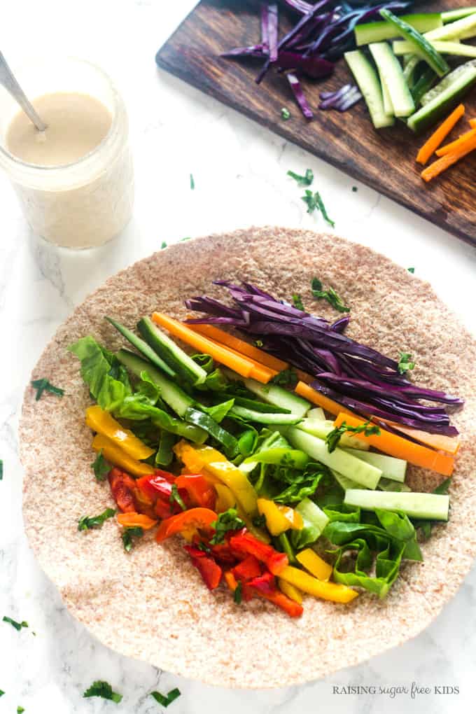 Rainbow Wraps with Peanut Sauce | Raising Sugar Free Kids - this delicious lunch is packed full of vegetables in all colours, and covered in a simple, yummy sugar free peanut sauce. Making "eating the rainbow" fun and easy. #sugarfree #vegpower #eattherainbow 