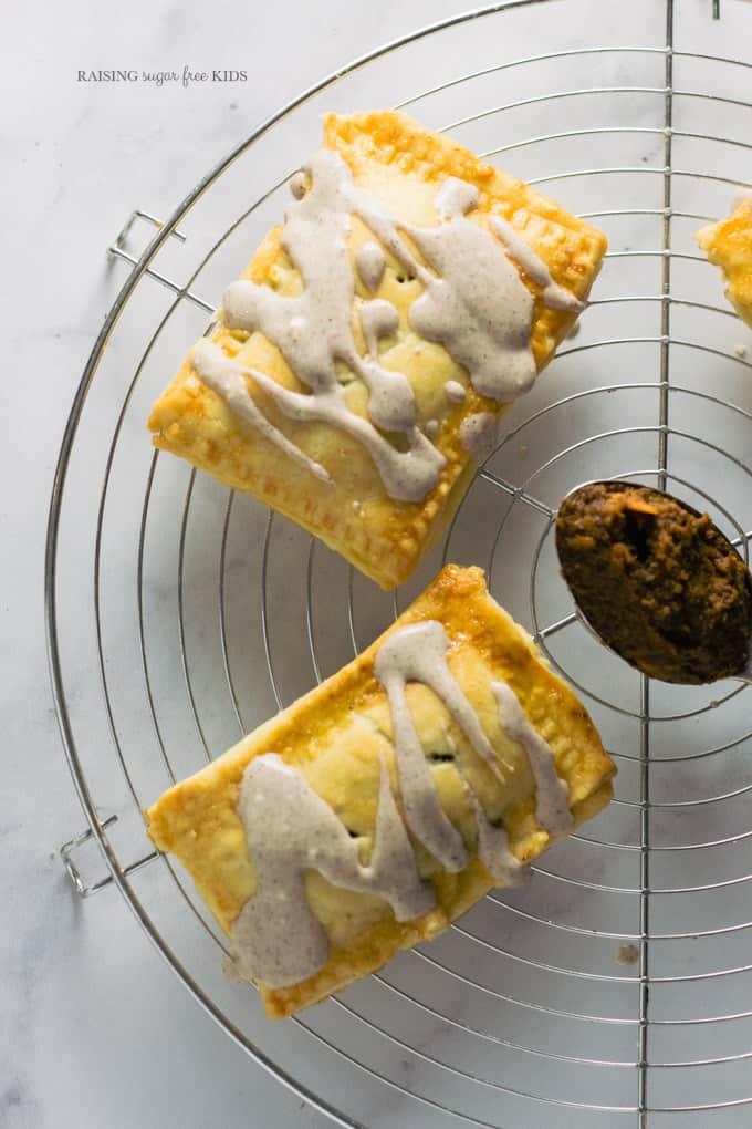 Sugar Free Pumpkin Pie Pop-Tarts | Raising Sugar Free Kids - delicious flaky pastry filled with warming, sweet pumpkin pie filling and finished with a yogurt pumpkin spice glaze. These pop-tarts are delicious, and they just happen to also be sugar free! #sugarfree #pumpkin #fall 