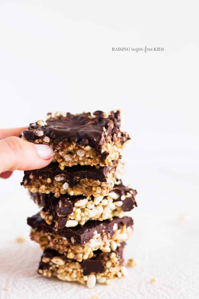 Low Sugar Scotcheroos | Raising Sugar Free Kids - these peanut butter puffed rice bars are sweet, fudgy and delicious. They are also low in sugar, fructose free, gluten free and vegan. They are simple to make, and contain only 1 tsp sugar per serve rather than the usual 7! #lowsugar #glutenfree #vegan #halloween 