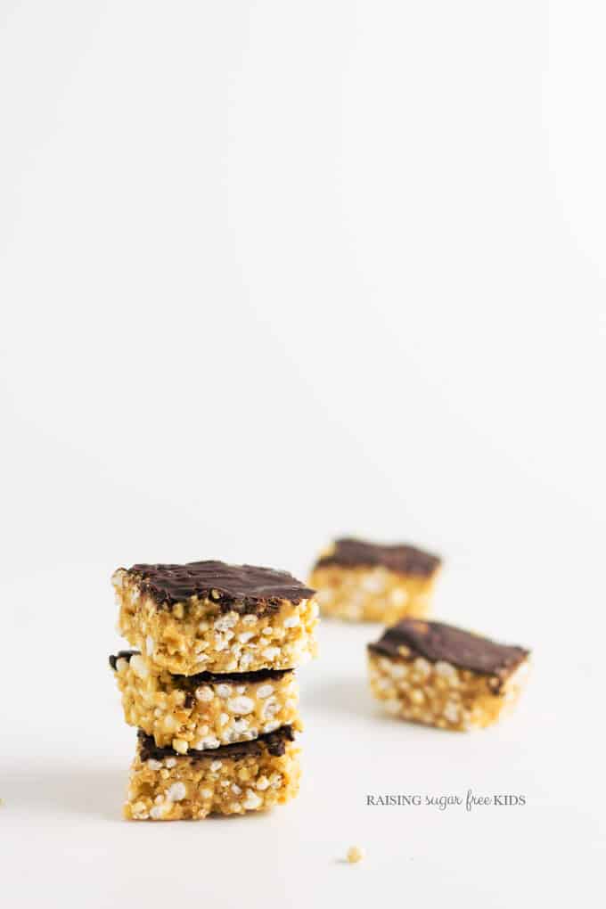 Low Sugar Scotcheroos | Raising Sugar Free Kids - these peanut butter puffed rice bars are sweet, fudgy and delicious. They are also low in sugar, fructose free, gluten free and vegan. They are simple to make, and contain only 1 tsp sugar per serve rather than the usual 7! #lowsugar #glutenfree #vegan #halloween 